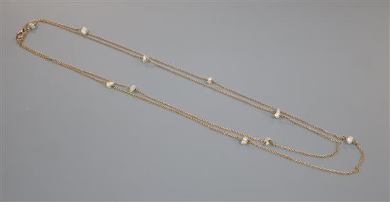 An early 20th century 15ct and baroque pearl set guard chain, gross 18.4 grams.